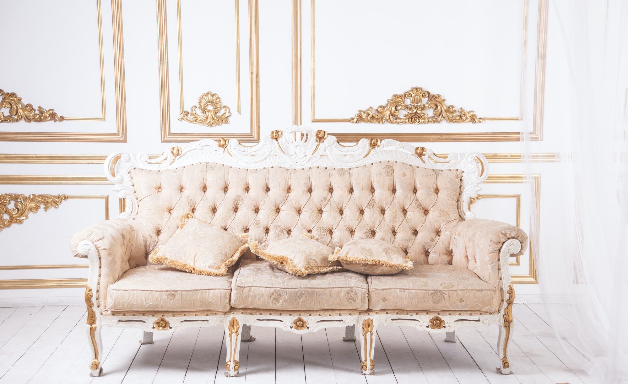 Antique luxury sofa against royal wall decoration.